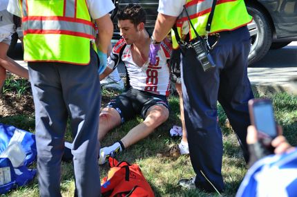 Injured cyclist getting help at bike race