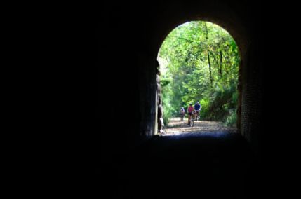 Bike riders entering Badger State Trail tunnel