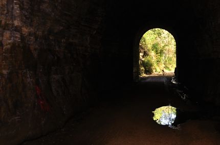 Tunnel entrance with reflection in puddle