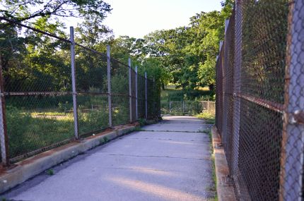 Rusty chain link fence crossing Willow Road