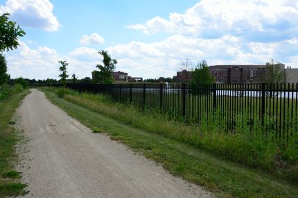 Wrought Iron fence next to crushed stone bike trail