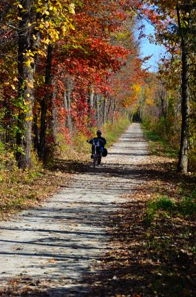 Bright fall colors and recumbent rider on I&M Trail