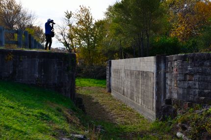 Photographer taking photo of lock on canal trail