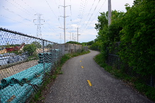 Bike path with cyclone fence and pipes