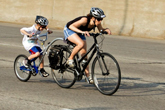 Woman and child racing down lake shore drive hill